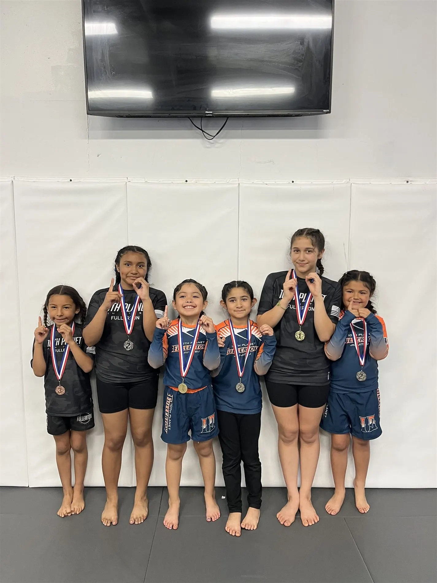 Youth jiu-jitsu competition team with medals at 10th Planet Orange