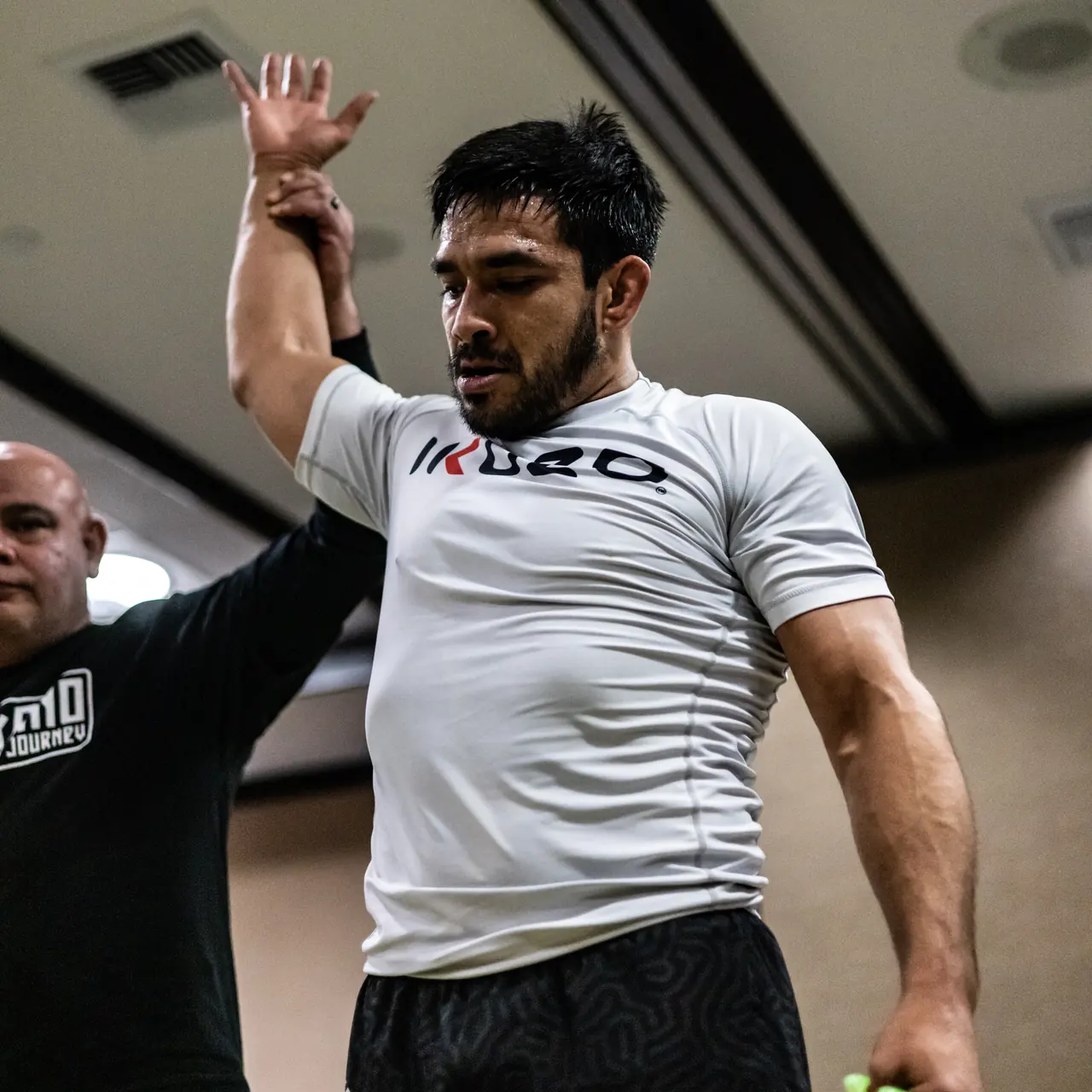 10th Planet Orange competitor having his hand raised in victory
